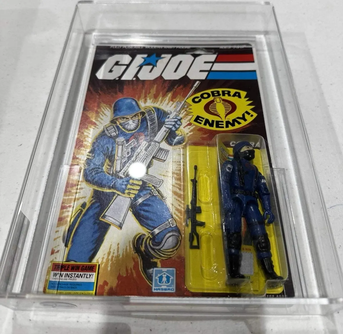 A 1985 Hasbro G.I. Joe Cobra figure sealed in an AFA acrylic case