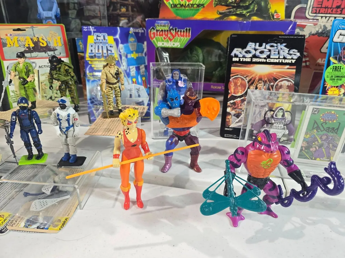 Vintage action figures and carded toys on display