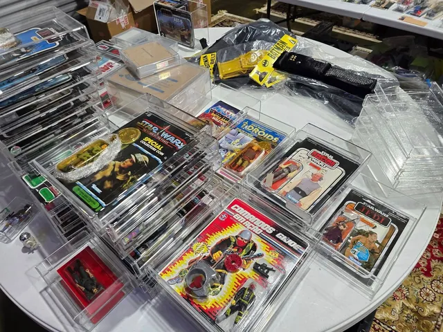 Bins of vintage toys and carded figures from several toy lines